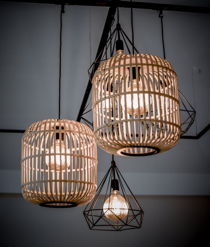 our-experience Chic boho-style lights hang from the ceiling, illuminating a modern indoor space.